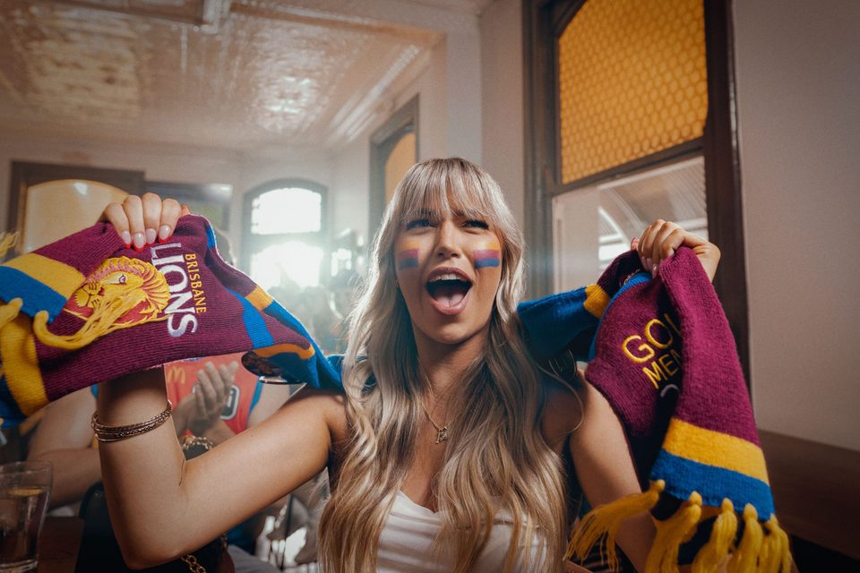 Brisbane Lions supporter in the club's lion-print jumper